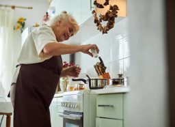 mature woman making soup in kitchen, concept of what world's longest living family eats every day